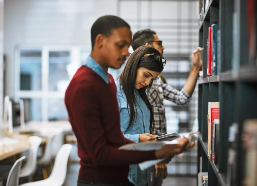 Students browsing books in the faculty library